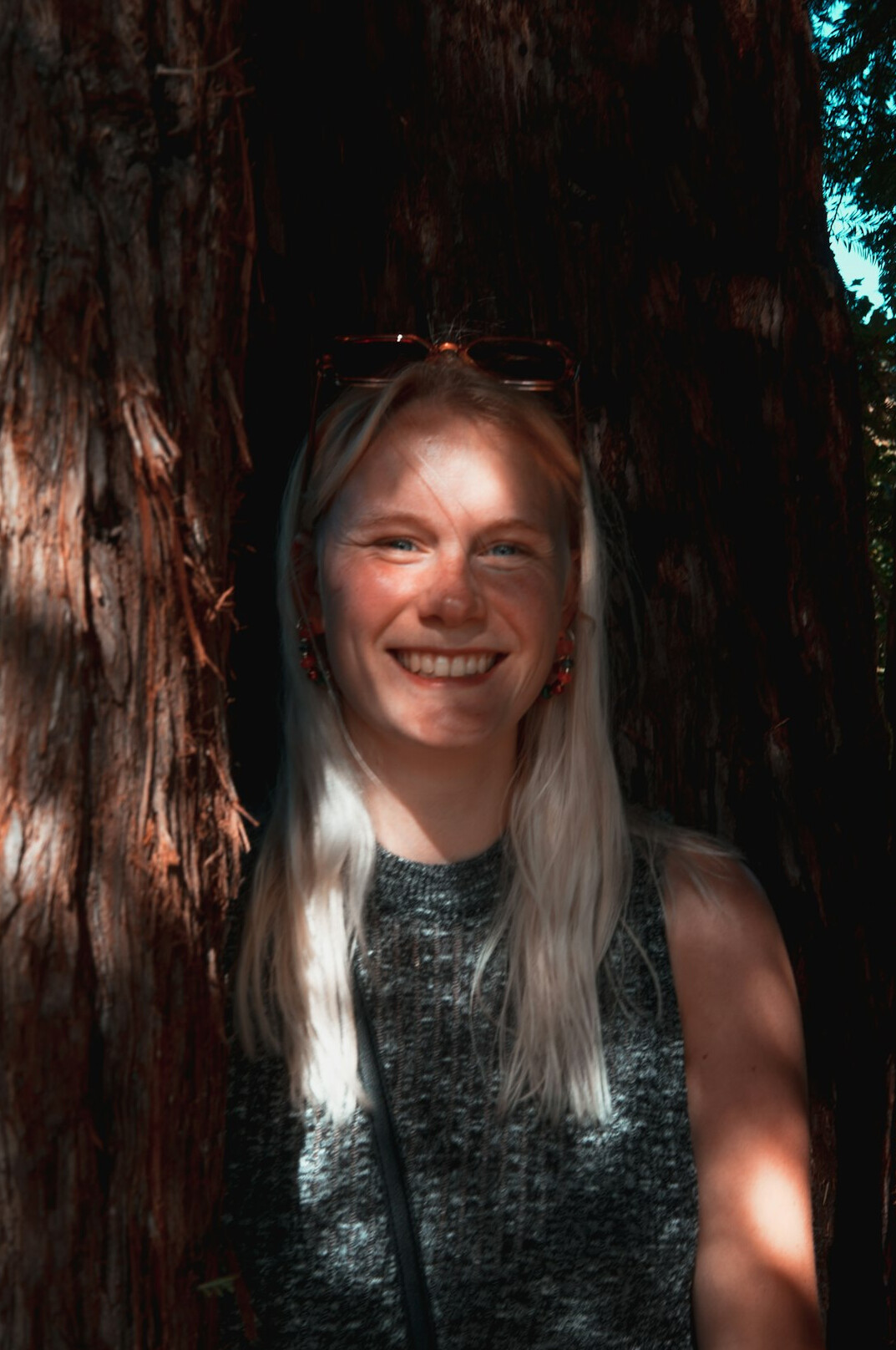 Portrait of a woman with light hair smiling at the camera